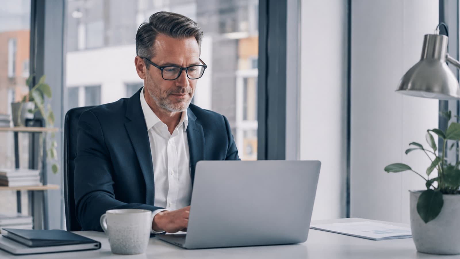 Financial advice firm director preparing a Consumer Duty board report at his laptop